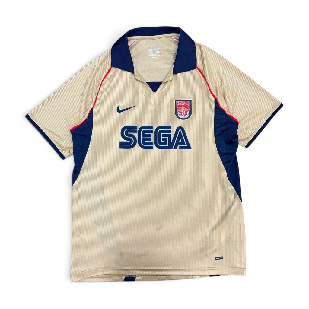mestizo vintage Arsenal FC gold away jersey with navy collar, SEGA sponsor, and Nike Dri-FIT fabric