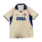 mestizo vintage Arsenal FC gold away jersey with navy collar, SEGA sponsor, and Nike Dri-FIT fabric